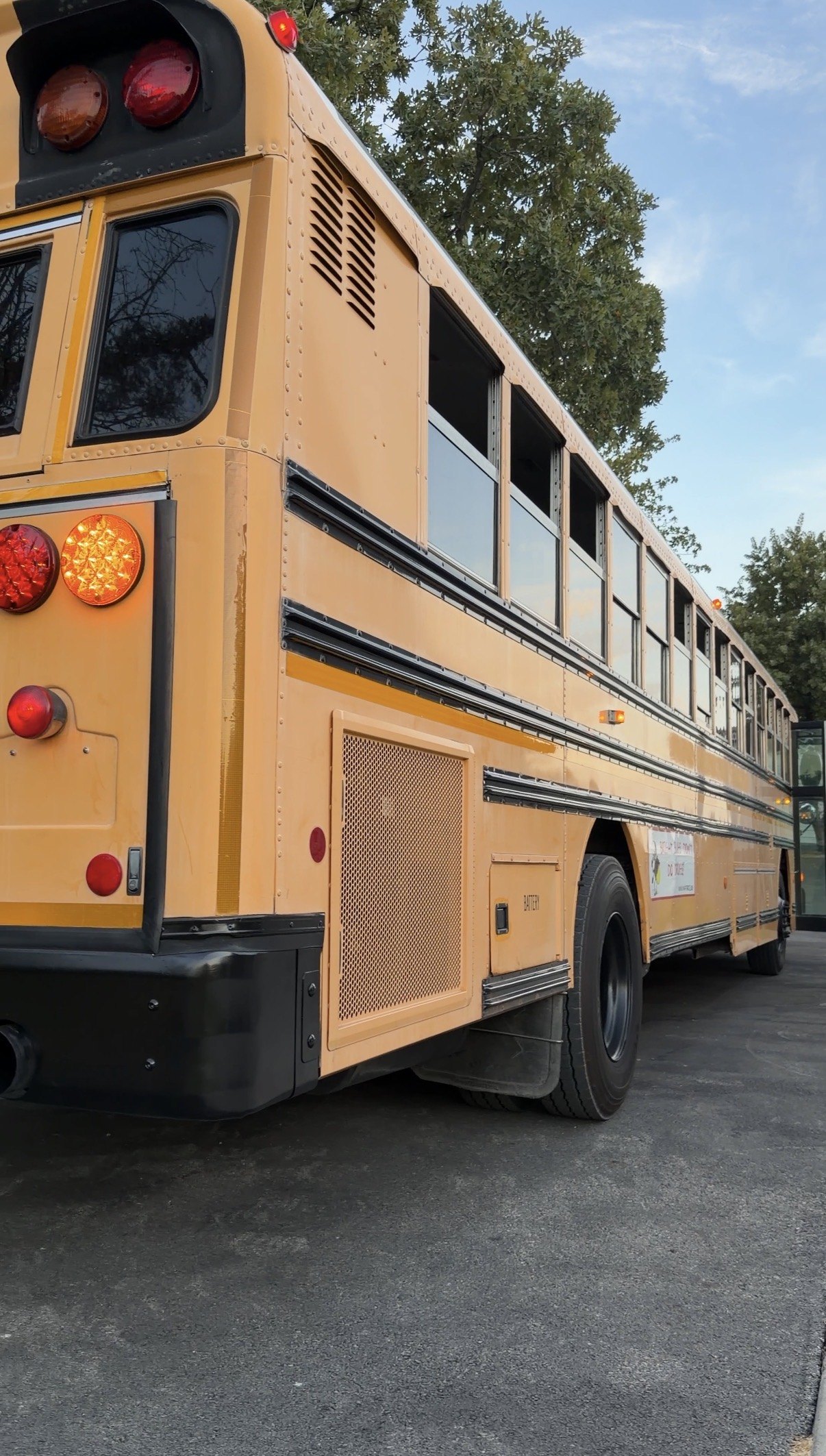 Rear-side view of the Rolling Transportation Discovery Blue Bird All American RE