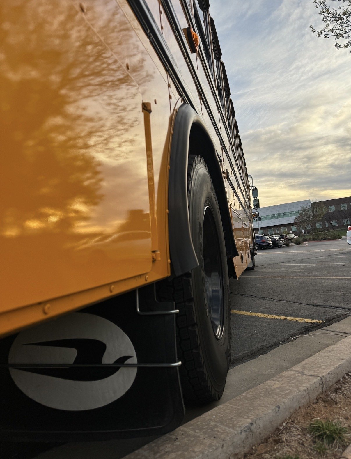Close-up reflection view along the side of the school bus