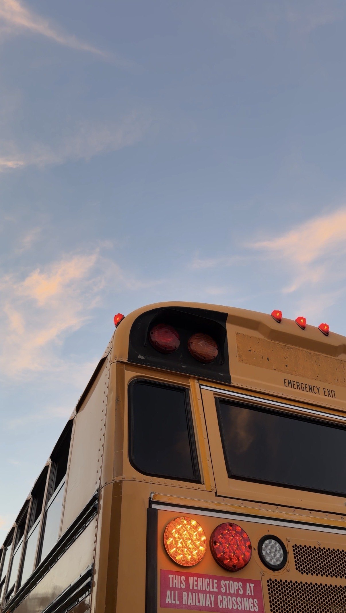 Rear upper corner of the school bus against the evening sky